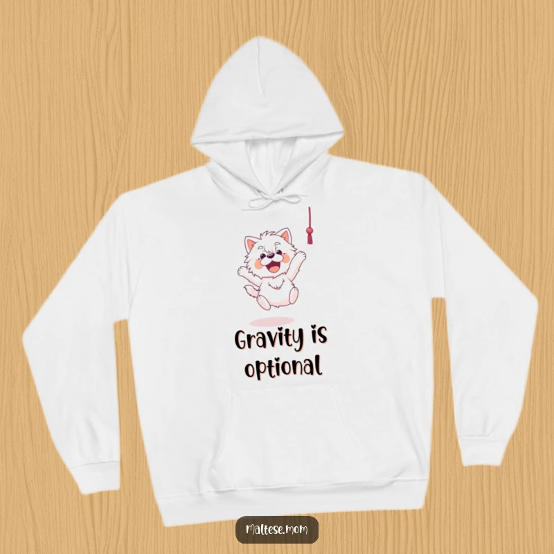 Funny Maltese hoodie depicting a Maltese dog joyfully leaping towards a dangling string, captured in a moment of energetic play.