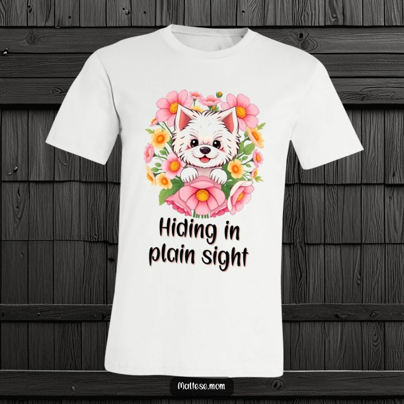 Funny Maltese t-shirt showing a smiling Maltese peeking out from a big cluster of bright flowers, a symbol of hidden joy.